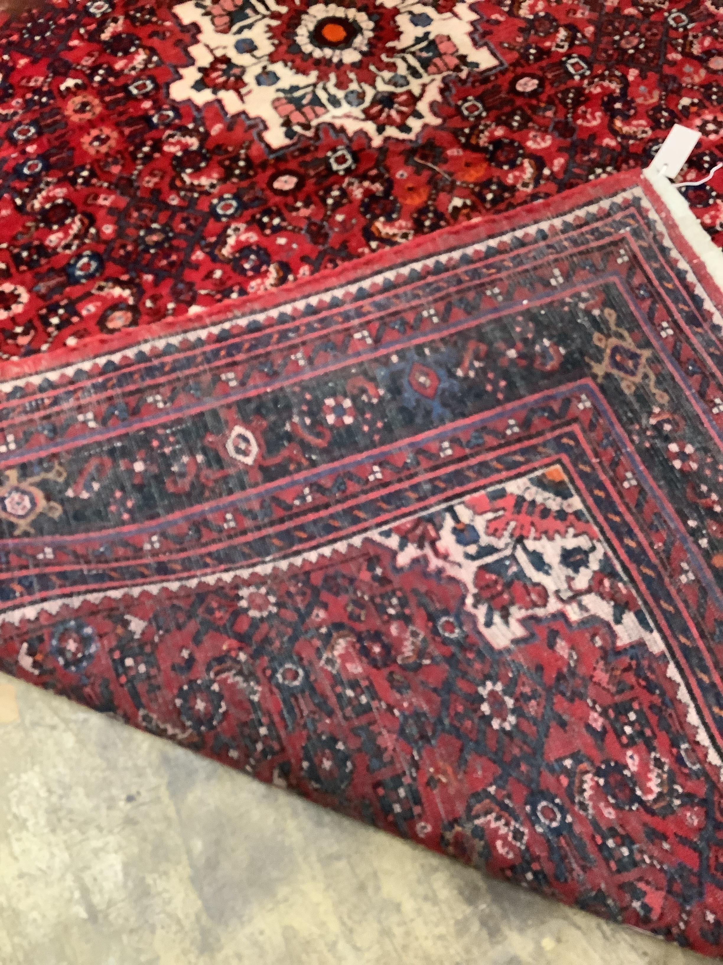 A North West Persian red ground carpet, 310cm x 215cm.
